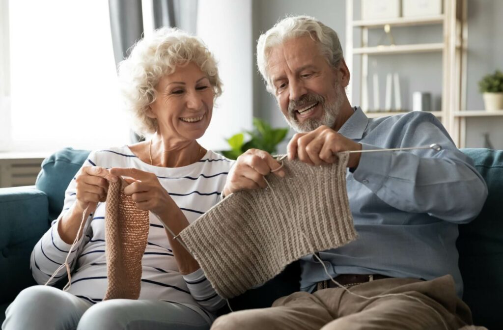 A caregiver redirects their loved one's attention by knitting together.